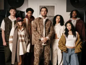 Athletes Anna Frey, Azzi Fudd, Drew Allar, Jeremiah Smith, Kiyan Anthony, Suni Lee, and Travis Kelce pose wearing the AE x Tru Kolors by Travis Kelce collection.