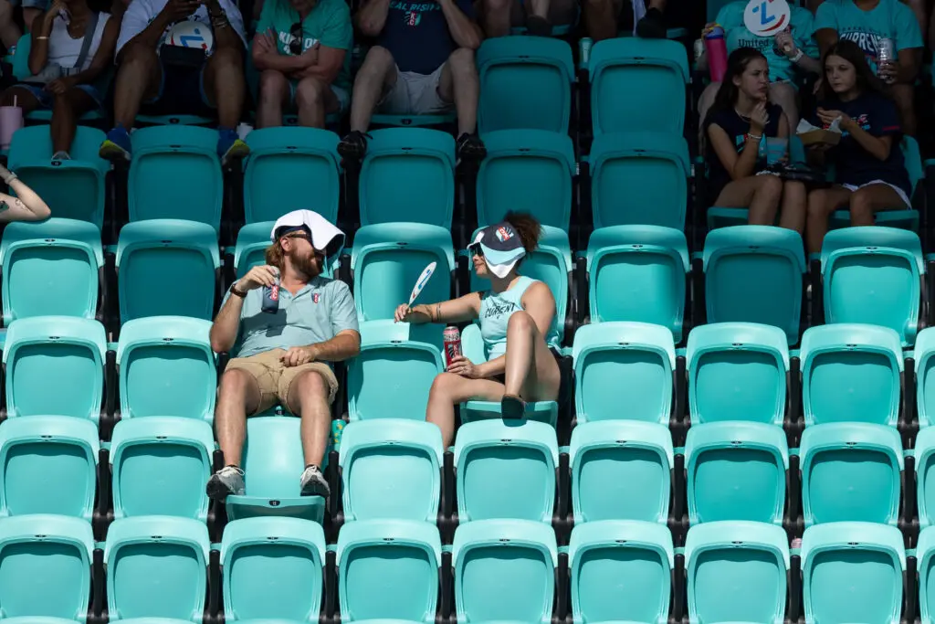 Kansas City Current fans attempt to stay cool during a heat delay at an August 2025 NWSL match.