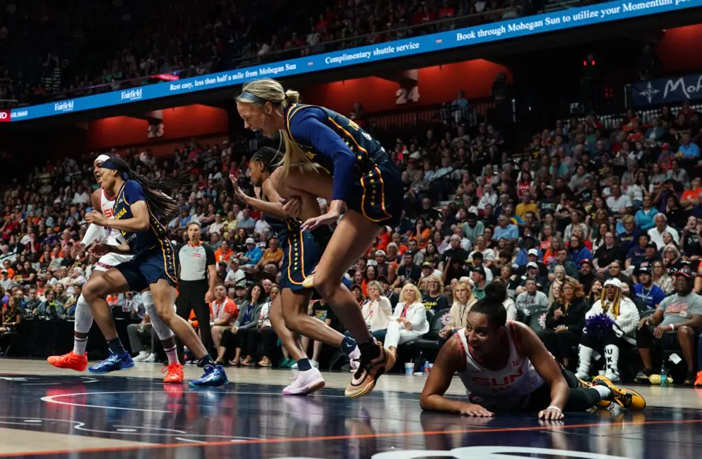Indiana Fever guard Sophie Cunningham clutches her knee after being injured during a 2025 WNBA game.