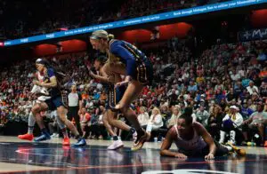 Indiana Fever guard Sophie Cunningham clutches her knee after being injured during a 2025 WNBA game.