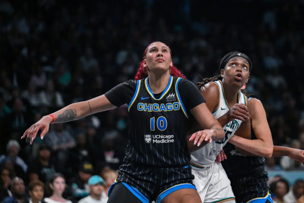 Chicago Sky center Kamilla Cardoso and New York Liberty center Jonquel Jones jockey for positioning during a 2025 WNBA game.
