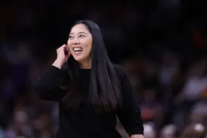Natalie Nakase, head coach smiles towards her team during the second quarter against the Phoenix Mercury at PHX Arena on May 11, 2025 in Phoenix, Arizona.
