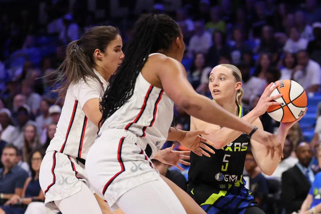 Washington Mystics guard Sonia Citron and forward Kiki Iriafen defend Dallas Wings guard Paige Bueckers during a 2025 WNBA game.