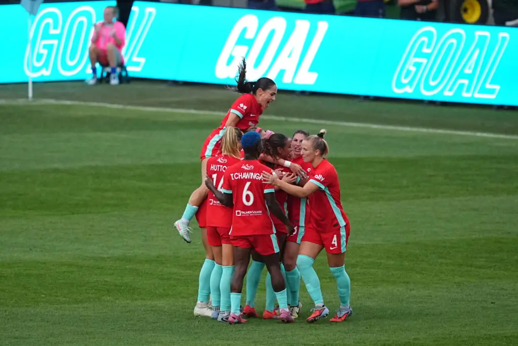 The Kansas City Current celebrate a goal by left back Izzy Rodriguez during a 2025 NWSL match.