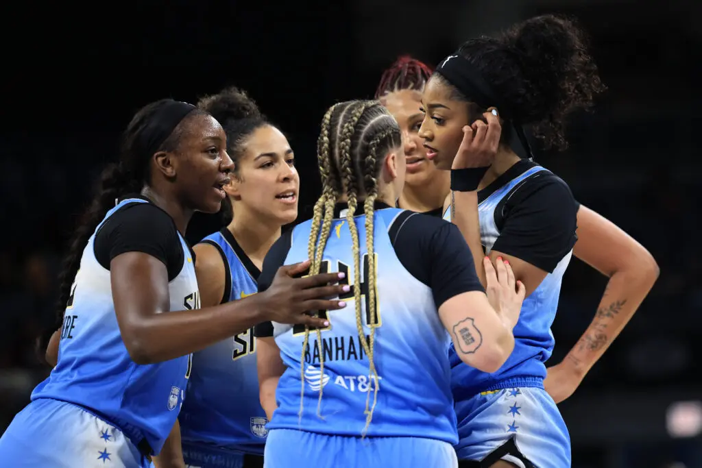 Angel Reese is consoled by her Chicago Sky teammates after being fouled during a 2025 WNBA game.