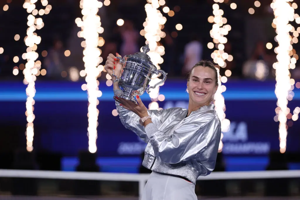 World No. 1 tennis player Aryna Sabalenka poses with her 2025 US Open trophy.