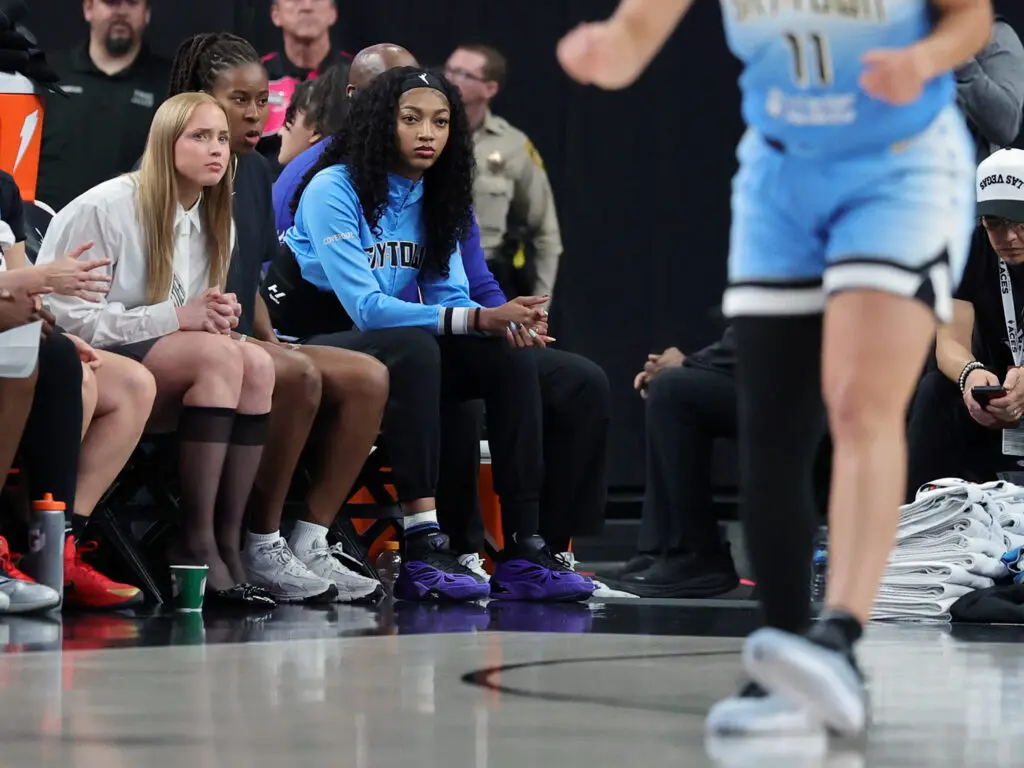 Chicago Sky guards Hailey Van Lith and Ariel Atkins, as well as forward Angel Reese, watch from the the bench during a 2025 WNBA game.