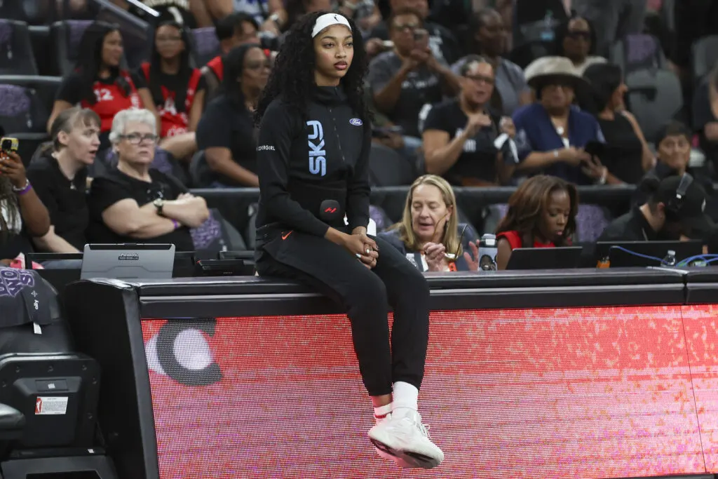 Chicago Sky forward sits on the scorer's table before a 2025 WNBA game.