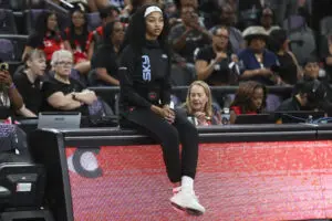 Chicago Sky forward sits on the scorer's table before a 2025 WNBA game.