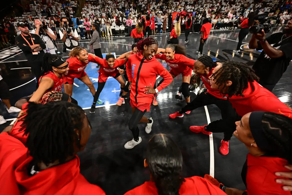 The Atlanta Dream smile and huddle before their Game 1 matchup against the Indiana Fever in the first round of the 2025 WNBA Playoffs.