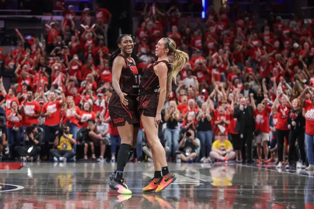 Indiana Fever teammates Aliyah Boston and Lexie Hull chest-bump in celebration of their Game 2 win in the first round of the 2025 WNBA Playoffs.