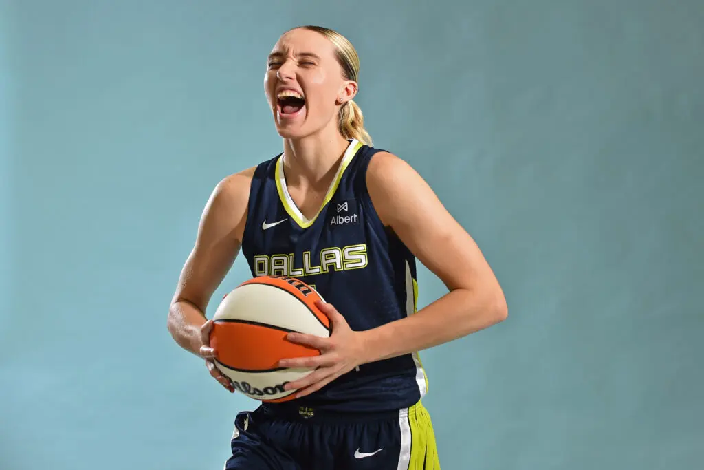 Dallas Wings rookie Paige Bueckers poses holding a basketball.