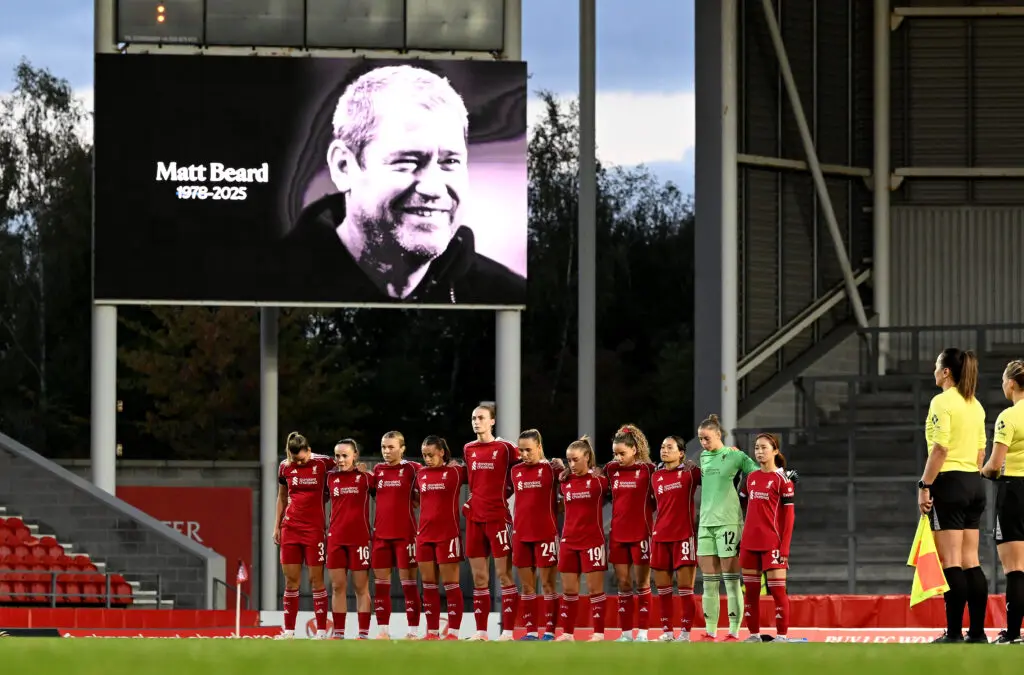 Liverpool players stand and observe a minute of silence in remembrance of former manager Matt Beard before a 2025 League Cup match.