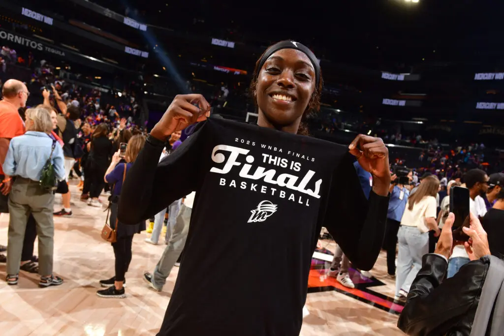 Phoenix Mercury star Kahleah Copper proudly poses in her "This is Finals basketball" T-shirt following her team's series win in the 2025 WNBA semifinals.