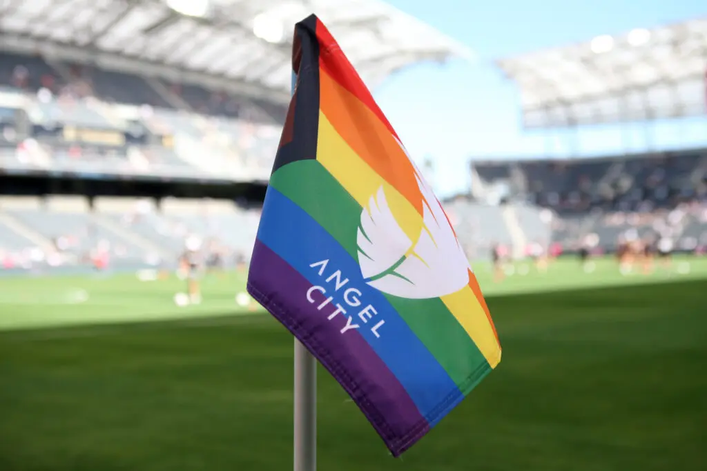 A Pride celebration Angel City corner flag awaits a 2023 NWSL match.