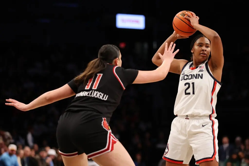 UConn basketball star Sarah Strong looks to pass the ball during a December 2024 NCAA game.