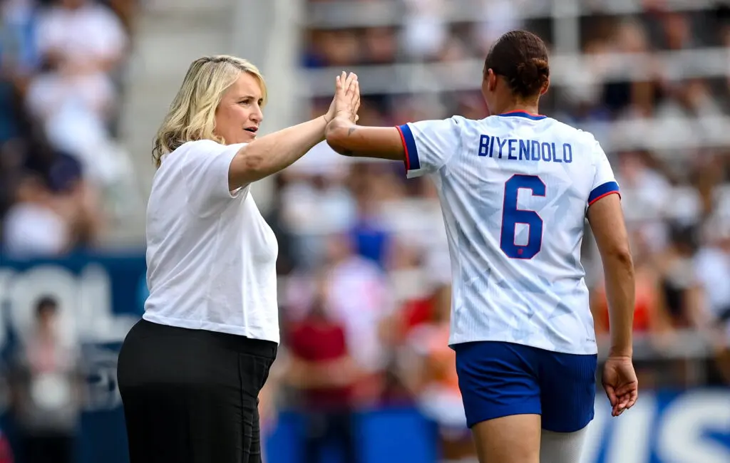 USWNT head coach Emma Hayes high-fives forward Lynn Biyendolo during a June 2025 friendly.