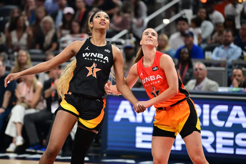 Team Collier's Angel Reese and Team Clark's Sabrina Ionescu eye the ball during the 2025 WNBA All-Star Game.