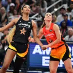 Team Collier's Angel Reese and Team Clark's Sabrina Ionescu eye the ball during the 2025 WNBA All-Star Game.