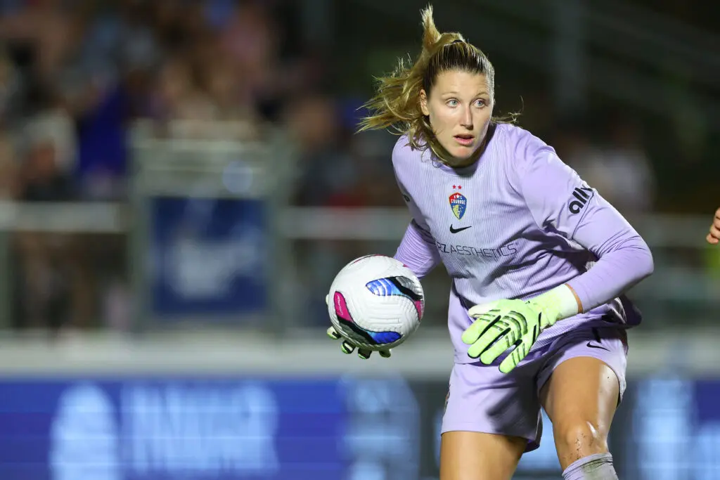 North Carolina Courage goalkeeper Casey Murphy puts the ball back in play after making a save in a 2025 NWSL match.
