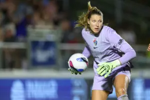 North Carolina Courage goalkeeper Casey Murphy puts the ball back in play after making a save in a 2025 NWSL match.