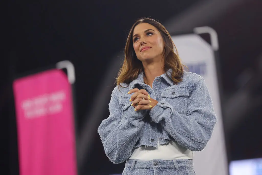 Alex Morgan reacts during her San Diego Wave jersey retirement at a 2025 NWSL match.