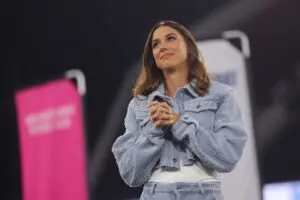 Alex Morgan reacts during her San Diego Wave jersey retirement at a 2025 NWSL match.