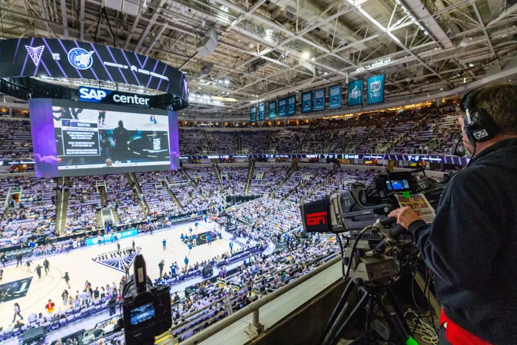 An ESPN camera man zooms in on a 2025 WNBA Playoffs game.