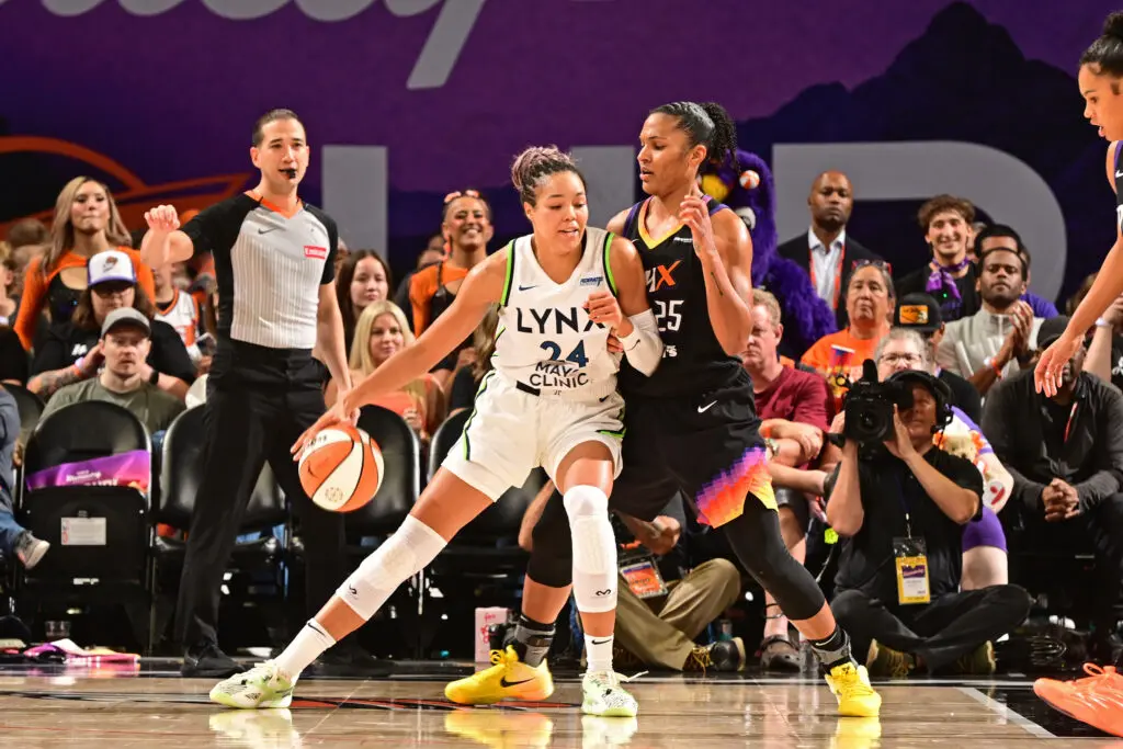 Phoenix Mercury forward Alyssa Thomas defends as Minnesota Lynx star Napheesa Collier dribbles during a 2025 WNBA semifinals game.