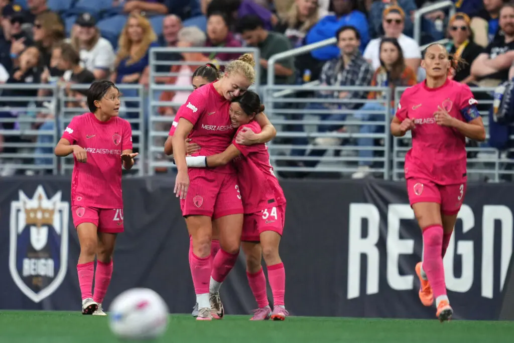 North Carolina Courage midfielder Manaka Matsukubo hugs forward Hannah Betfort after Betfort's goal during a 2025 NWSL match.