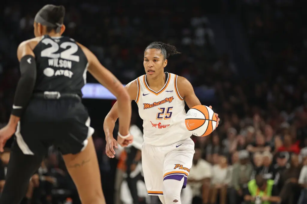 Phoenix Mercury forward Alyssa Thomas dribbles the ball while Las Vegas Aces star A'ja Wilson defends during Game 2 of the 2025 WNBA Finals.