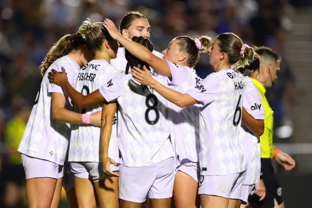 Racing Louisville FC players celebrate a goal during a 2025 NWSL match.