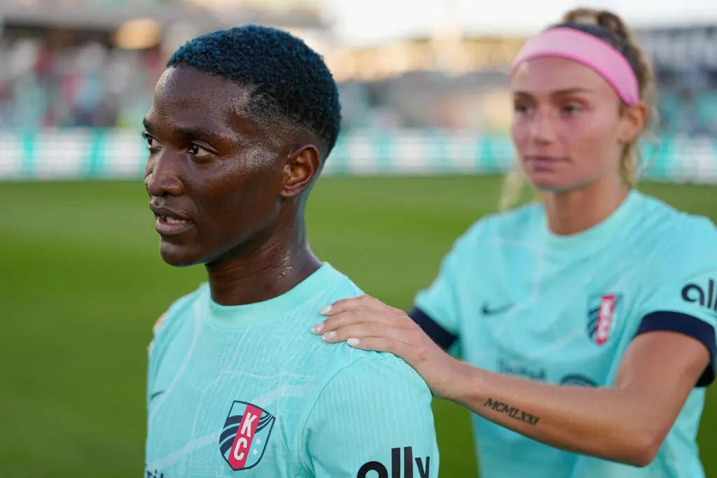 Kansas City Current defender Ellie Wheeler rests her hands on the shoulders of striker Temwa Chawinga after a 2025 NWSL match.