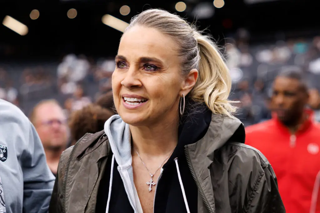 Las Vegas Aces head coach Becky Hammon looks on from the NFL sidelines during a 2025 game.