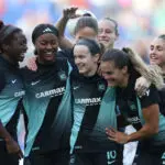 Gotham midfielder Rose Lavelle celebrates a goal with her teammates during a 2025 NWSL match.