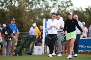 WNBA guard Caitlin Clark laughs with LPGA star Nelly Korda in the 2024 Pro-Am at The Annika tournament.