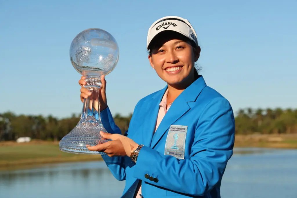 Thai golf star Jeeno Thitikul poses holding her 2024 CME Group Tour Championship trophy.