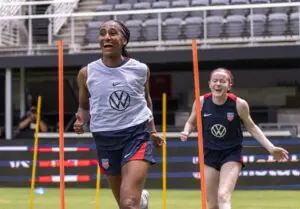 USWNT stars Naomi Girma and Rose Lavelle laugh during a 2025 training session.