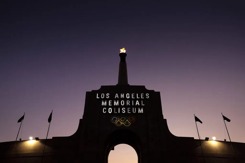 A flame flickers in the Olympic torch above Los Angeles Memorial Coliseum.