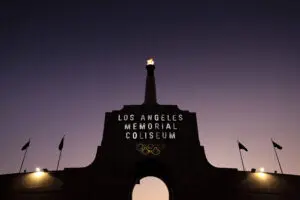 A flame flickers in the Olympic torch above Los Angeles Memorial Coliseum.