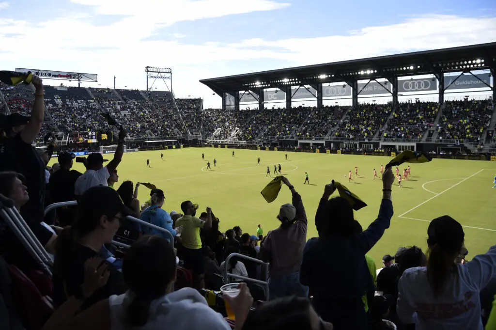 Fans cheer at the Washington Spirit's Audi Field during a 2025 NWSL match.
