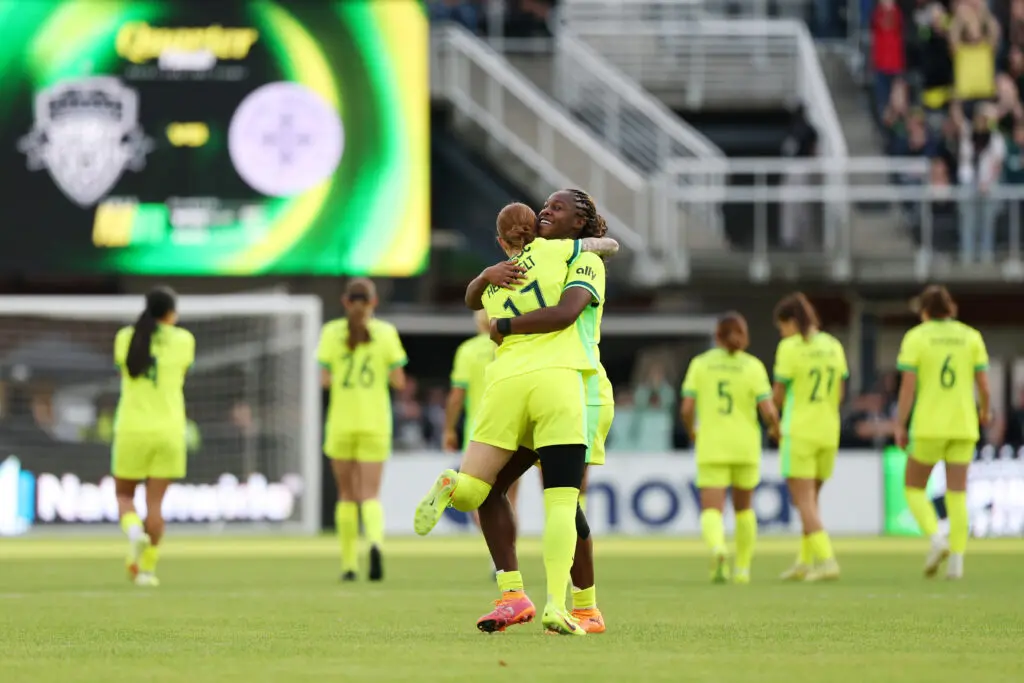 Washington midfielder Hal Hershfelt hugs center back Kysha Sylla after the Spirit's penalty shootout win over Racing Louisville in the 2025 NWSL Playoffs.