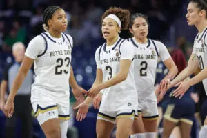 Notre Dame guard Hannah Hidalgo high-fives teammates during a 2025/26 NCAA basketball game.