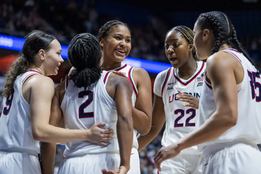 No. 1 UConn basketball celebrates a play during their 2025/26 NCAA game against No. 6 Michigan.