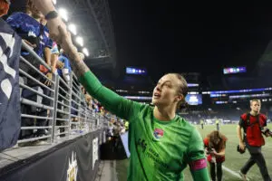 San Diego Wave goalkeeper Kailen Sheridan shakes a fan's hand after a 2025 NWSL match.