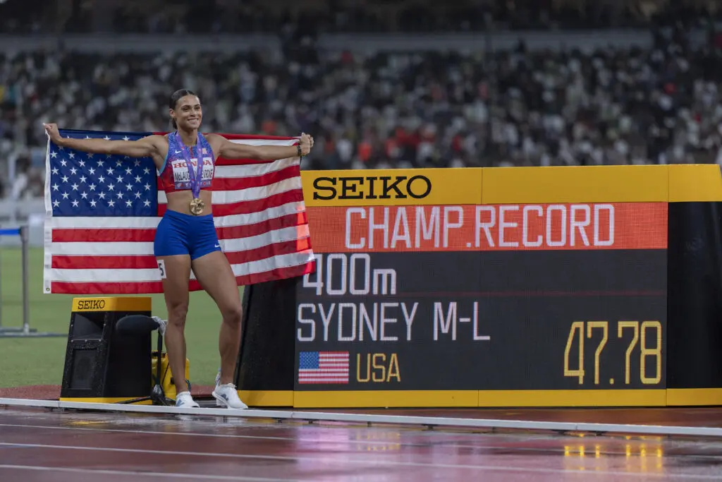 US track star Sydney McLaughlin-Levrone poses next to her 400-meter final championship-record time at the 2025 World Athletics Championships.