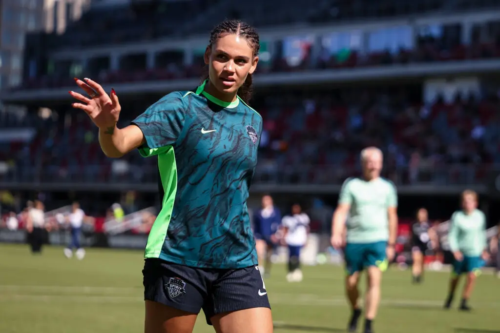 Washington Spirit star Trinity Rodman waves to fans before a 2025 NWSL match.