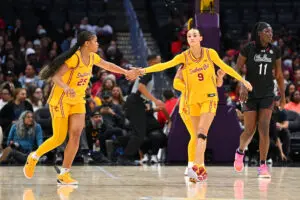 USC senior guard Kara Dunn high-fives freshman Jazzy Davidson during a 2025/26 NCAA basketball game.