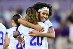 USWNT midfielder Lily Yohannes hugs goalscorer Catarina Macario during a 2025 friendly.
