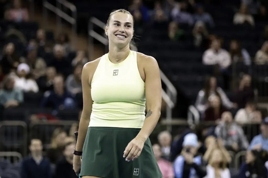 World No. 1 tennis star Aryna Sabalenka smiles during a 2025 exhibition match.